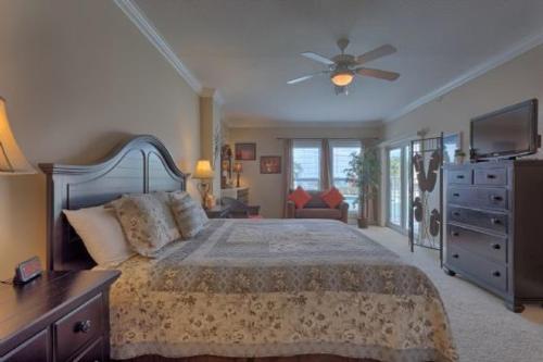 sypialnia z łóżkiem i wentylatorem sufitowym w obiekcie Paradise Shores 105 by Pristine Properties Vacation Rentals w mieście Mexico Beach