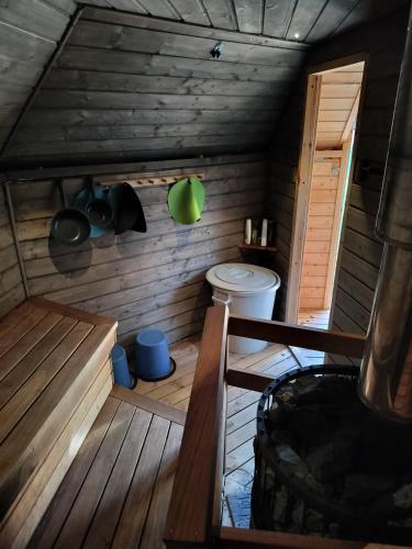 a bathroom with a toilet in a wooden house at Gäststuga och bastu in Oravais