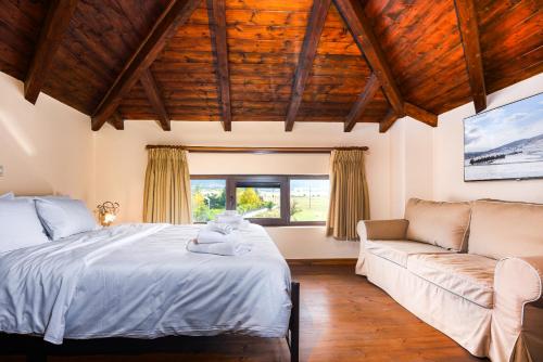 a bedroom with a bed and a couch at Chalet Panorama -Three Level Escape in Parnassos in Arachova