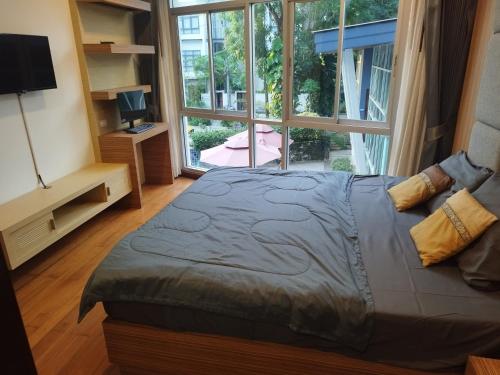 a bedroom with a large bed and a large window at Arisara Nest in Bophut 