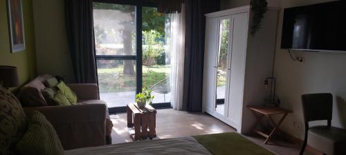 TV a/nebo společenská místnost v ubytování B&B 't Goedhof
