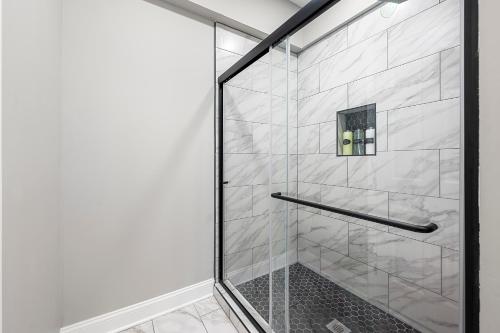 a shower with a glass door in a bathroom at Atlanta Modern Escape Prime Location & Spacious Living sleeps 14 in Atlanta