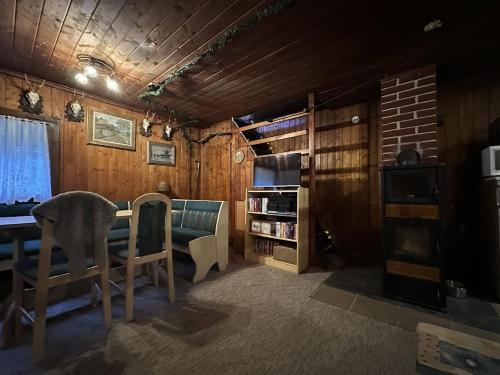 a dining room with a table and chairs in a room at Srub pod Lysou horou in Ostravice
