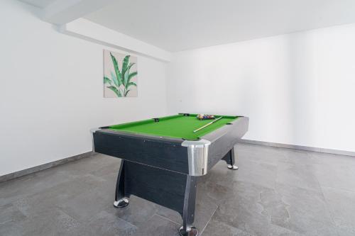 a pool table sitting in a room with a green at Villa Zen with sea view and private pool in Lourinhã