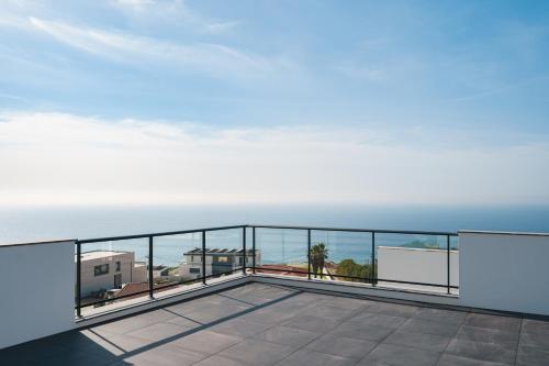 a balcony with a view of the ocean at Villa Zen with sea view and private pool in Lourinhã