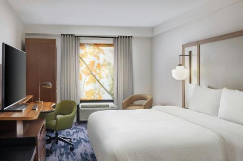 a hotel room with a bed and a desk and a television at Fairfield by Marriott Mission Viejo Orange County in Mission Viejo
