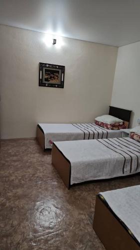 a room with three beds in a room at Sinichka in Cholpon-Ata