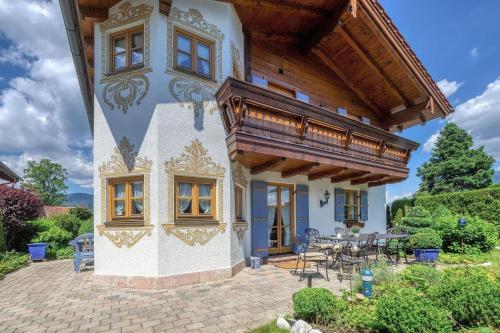 a house with a wooden roof and a patio at Landhaus Königssee in Schönau am Königssee