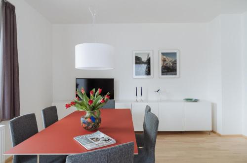 a dining room with a red table and chairs at Ferienwohnung Gute Laune in Berchtesgaden