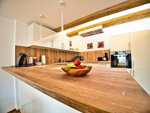 a kitchen with a bowl of fruit on a counter at Am Bruckenstüberl in Schönau am Königssee
