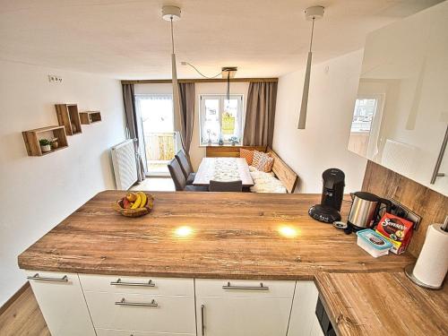 a kitchen with a counter top and a living room at Am Bruckenstüberl in Schönau am Königssee