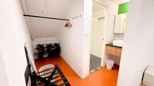 a small room with a hallway with a table and chairs at The companions house in Sathani Bang Su