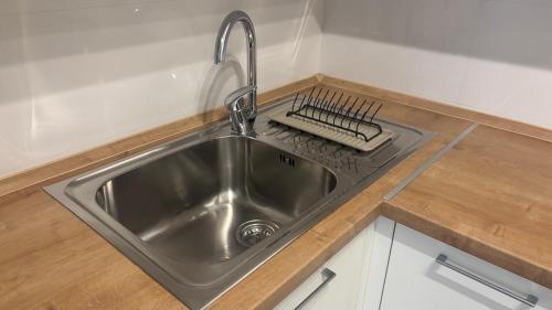 a kitchen sink with a faucet on a counter at Skopje home 5 in Skopje