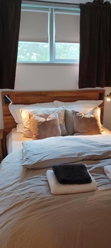 a large white bed with pillows and a window at Central apartment with 2 bedrooms in Tromsø