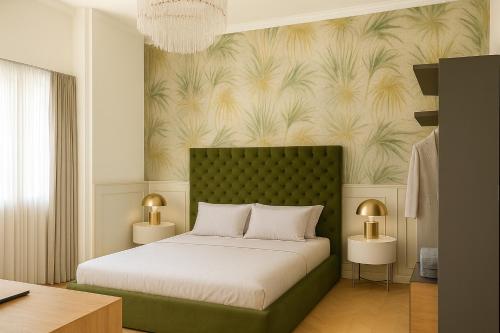 a bedroom with a bed with a green headboard at Incanto Relais & Charme - dBe Hotels in Florence