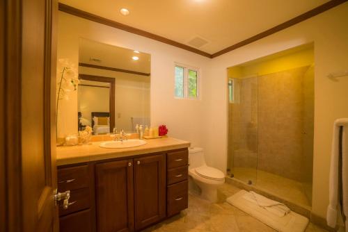 a bathroom with a sink and a toilet and a shower at Veranda 8H 3 bdr Garden View in Los Suenos in Herradura