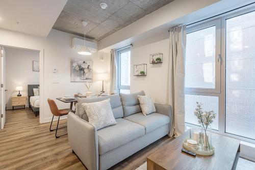 a living room with a couch and a table at Cute Gem in Downtown Montreal in Montréal