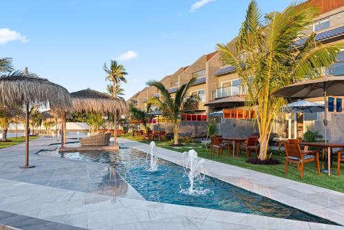 a resort with a fountain and tables and chairs at The sunset resorts - منتجع ساحل الغروب in Jeddah