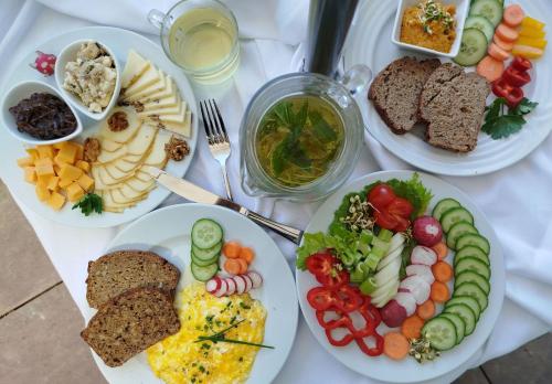a white table with plates of food on it at Hotel Chytrov in Volfířov