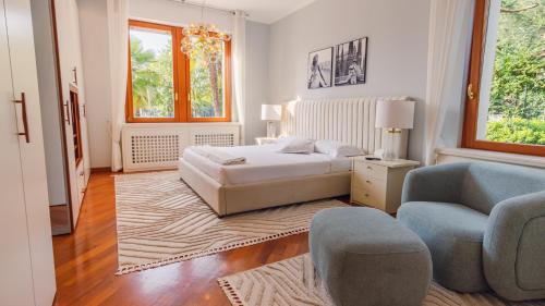 a bedroom with a bed and a couch and a chair at Villa Angela - Italian Homing in Desenzano del Garda