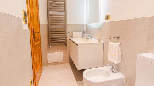 a small bathroom with a toilet and a sink at Villa Angela - Italian Homing in Desenzano del Garda