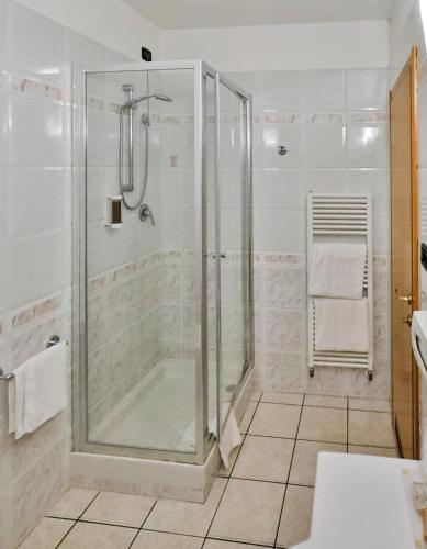 a bathroom with a shower with a glass shower stall at Hotel Molino Rosso in Imola