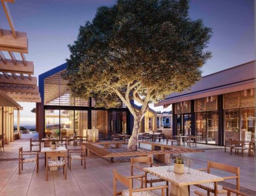 a restaurant with tables and chairs and a tree at Villa Arcadia, Kallepia in Paphos