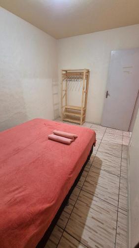 a bedroom with a bed with red sheets on it at Apartment in Rio Grande Great location in Rio Grande