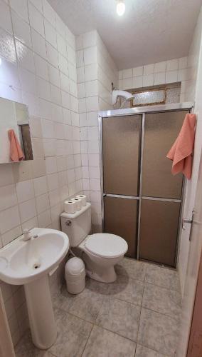 a bathroom with a toilet and a sink at Apartment in Rio Grande Great location in Rio Grande