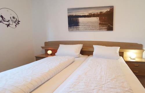 a bedroom with two beds and a picture on the wall at Ferienwohnungen Trattler in Chieming