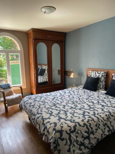 a bedroom with a large bed and a window at Le Havre de Braye in Braye-en-Laonnois