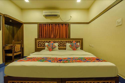 a bedroom with a bed and a air conditioner at FabHotel Shivalya in Kolkata
