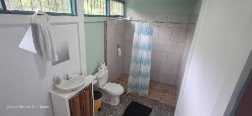 a bathroom with a shower and a toilet and a sink at Mountain Retreat in Bijagua de Upala with Stunning Nature Views in Bijagua