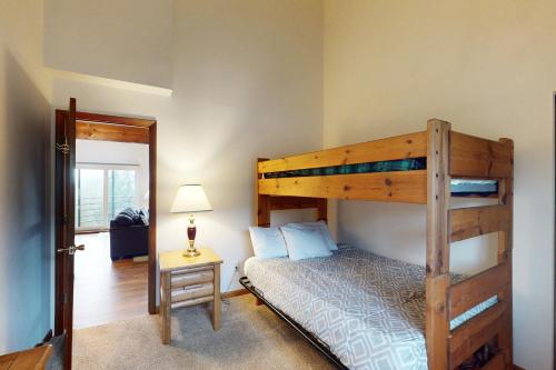 a bedroom with a wooden bunk bed with a night stand at Buffalo Ridge C302 in Silverthorne
