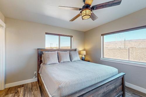 Un dormitorio con una cama y un ventilador de techo. en Rim View 4, en Spanish Valley