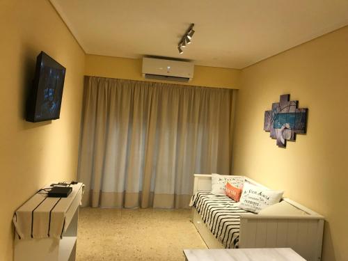 a living room with a couch and a tv at Vista al mar in Mar del Plata