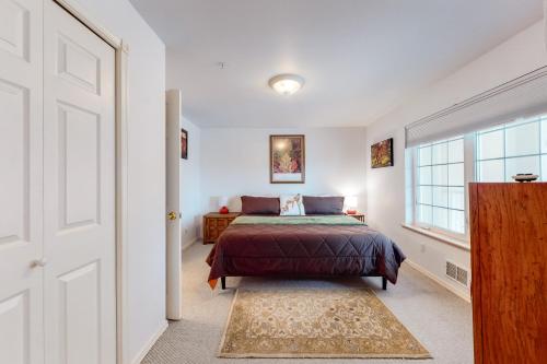a bedroom with a bed and a window at Surfsong in Westport