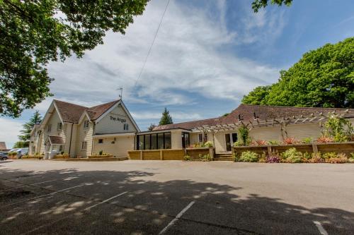 a large white building with a roof at The Angel Hotel in Alton