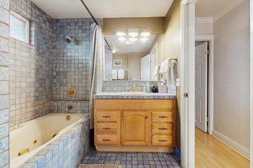 a bathroom with a tub and a sink at Kahaone Oasis (30+ night rental) in Waialua