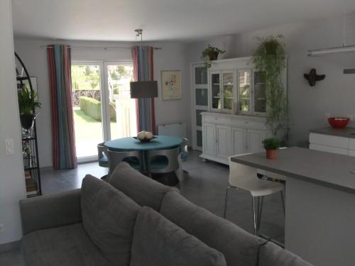 a living room with a couch and a table at Villa accueillante avec piscine à Castellane - 153 m² in Castellane
