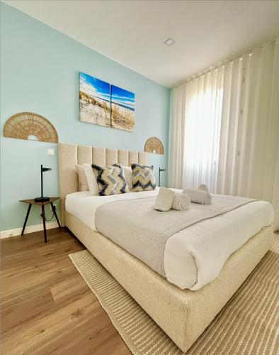 a large bed in a bedroom with blue walls at Water Vibes Porto by MyMoradia in Porto