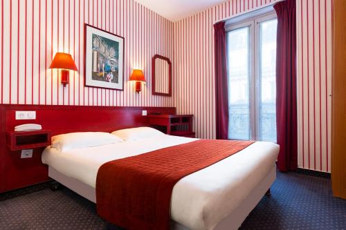 a bedroom with a large bed and a window at Maison Du Pré in Paris