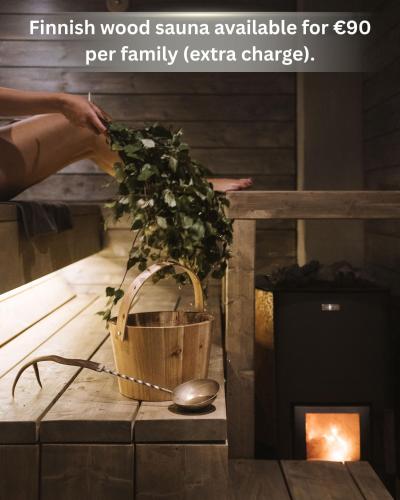 a plant in a wooden basket next to a fire place at Yurt District in Rovaniemi