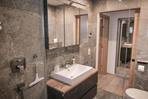 a bathroom with a sink and a shower at HOLARI Appartement in Reith bei Seefeld
