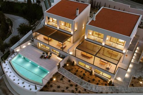 an aerial view of a house with a swimming pool at Majo Luxury Villas Panoramic Sea View Retreat with Heated Private Pools & Gym & Sauna in Agia Pelagia