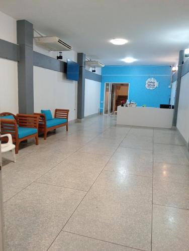 an empty lobby with chairs and a blue wall at Italay in Krabi
