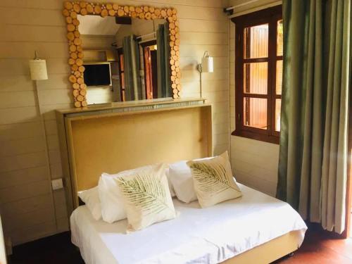 a bedroom with a bed with a large mirror at Charming apartment in Albion with shared pool, 20.3 m² in Albion