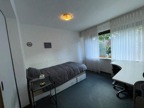 a bedroom with a bed and a desk and a window at detached bungalow, 5 beds wifi smart tv terras 3 parkings keybox in Emlichheim