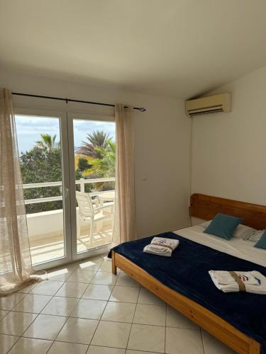 a bedroom with a bed and a view of a balcony at Murdeira V159D Duplex by RPG Group in Beirona
