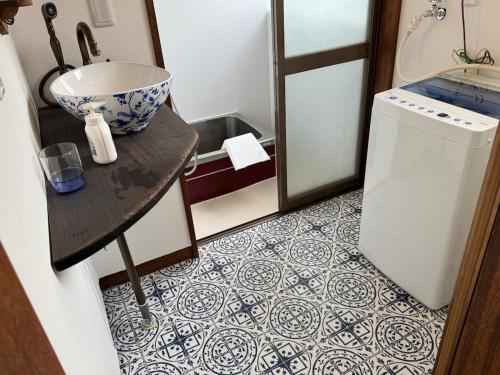 a small bathroom with a sink and a counter with a counter at 鶴岡市中心地ゲストハウス in Tsuruoka